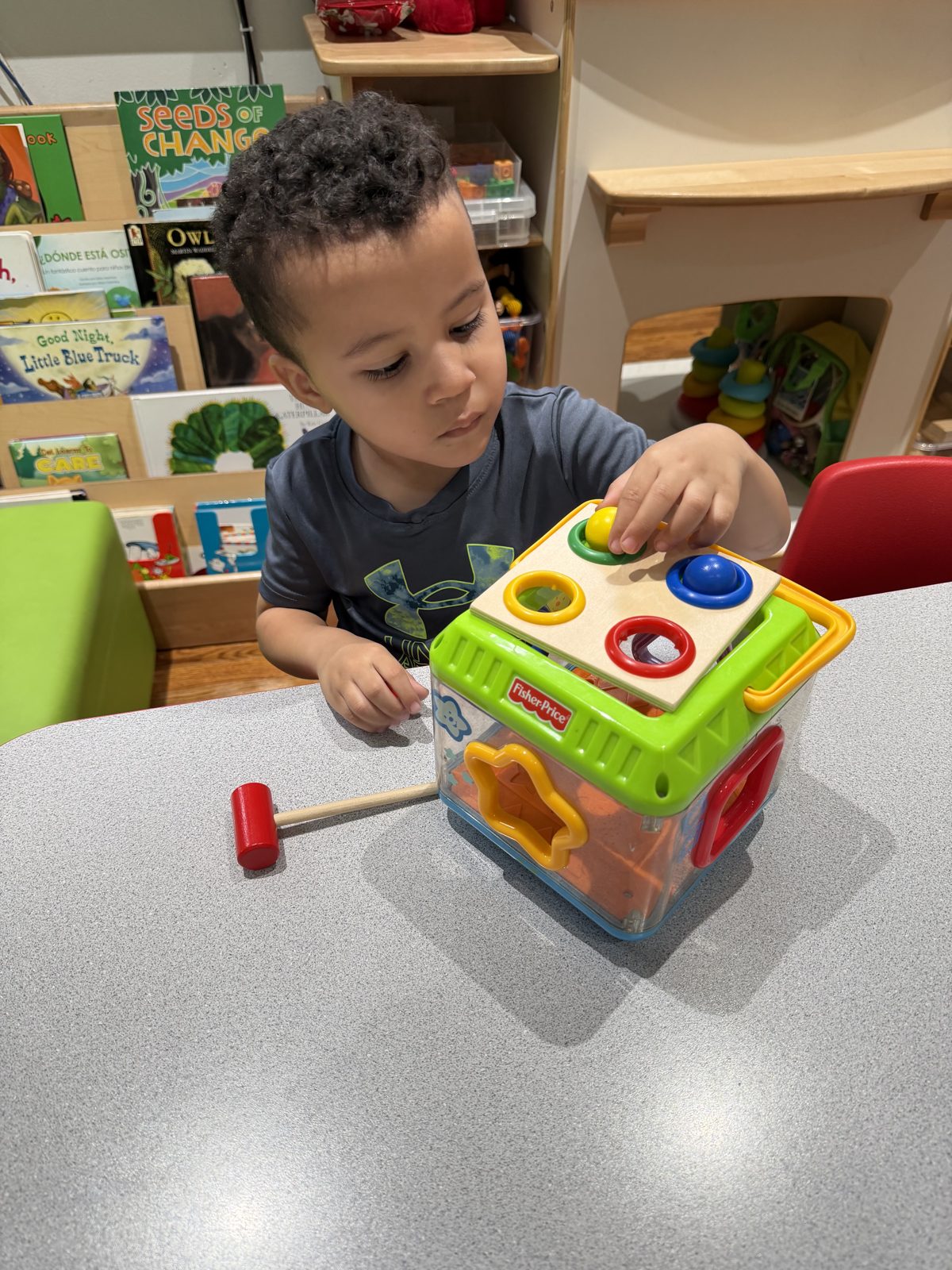 Toddler exploring a shape-sorting learning toy